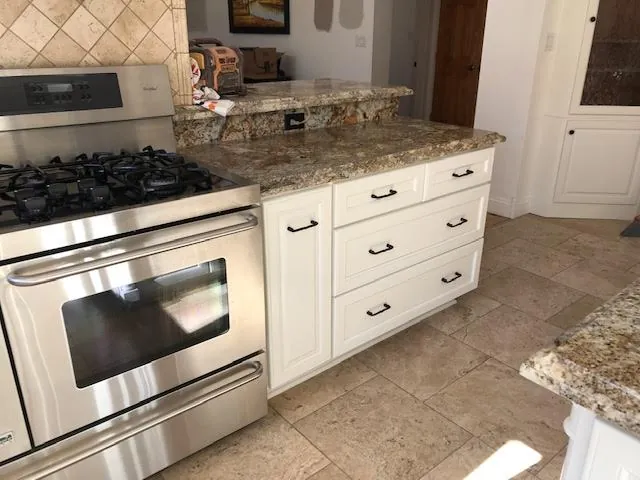 White refinished cabinets with granite counter