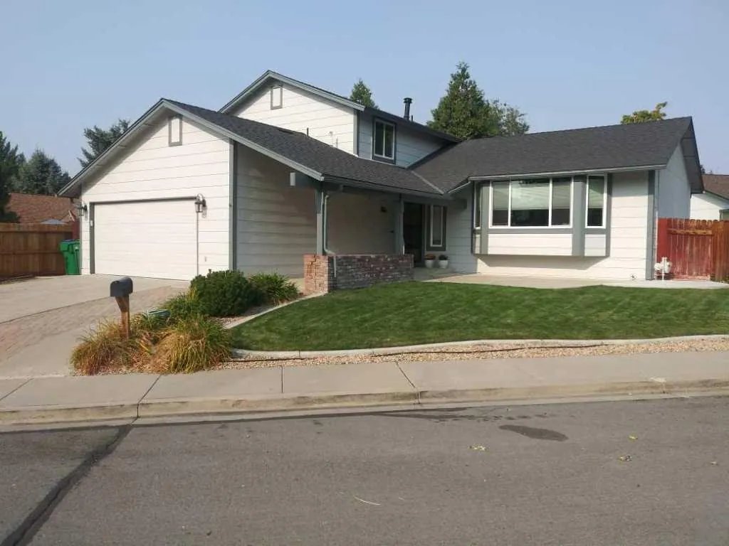 Two‑storey home in light grey with charcoal roof