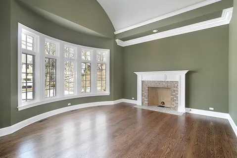 Sage green living room with white fireplace